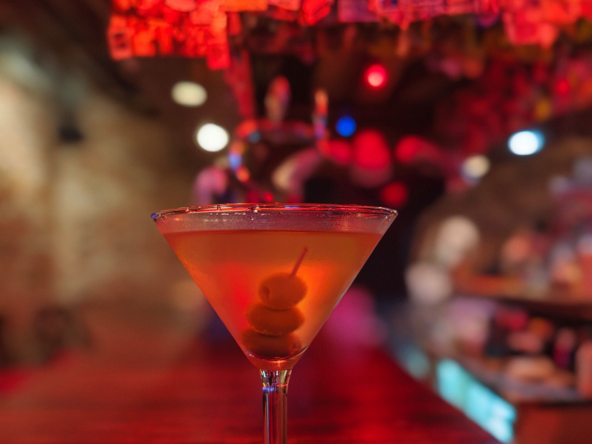 A vodka martini with three olives on the bar at Cinquecento